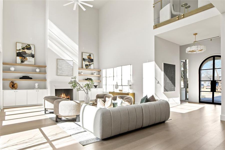 Spacious living area featuring double-height ceilings and wood-finish flooring