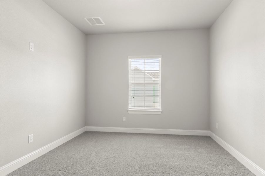 Carpeted spare room featuring baseboards Carpeted spare room featuring baseboards
