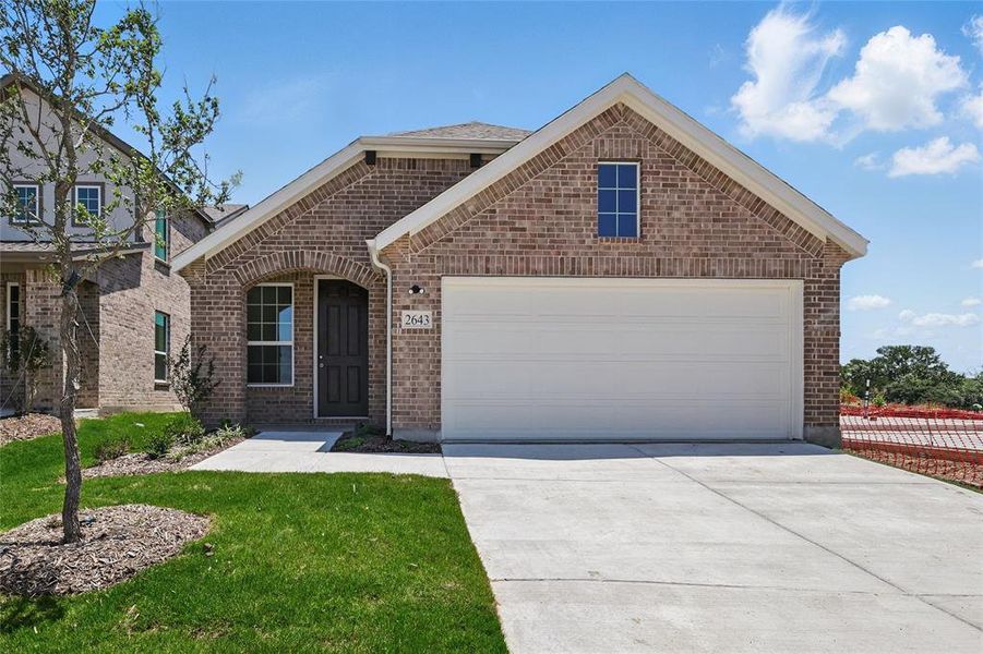 View of front of property featuring brick siding, driveway, and a garage View of front of property featuring brick siding, driveway, and a garage