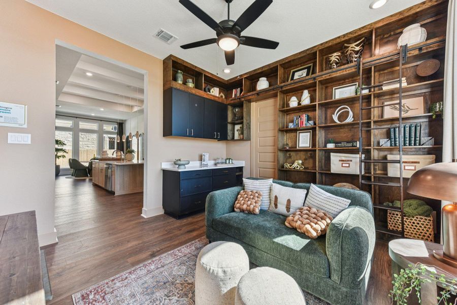 Rich wood shelving and warm flooring define this inviting open concept living space.