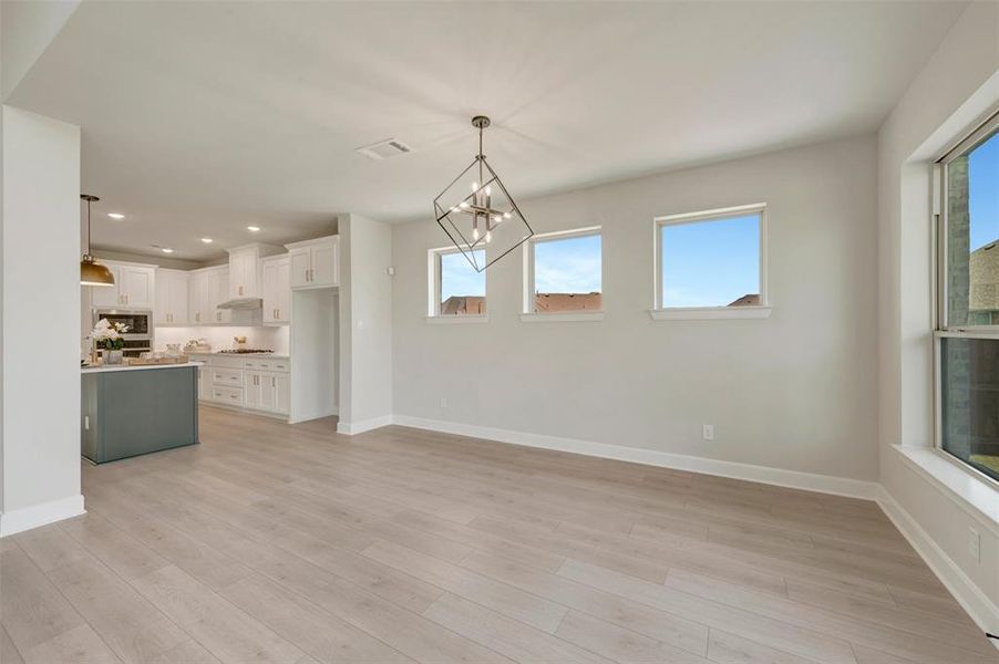 Open-concept living area with light wood-finish flooring