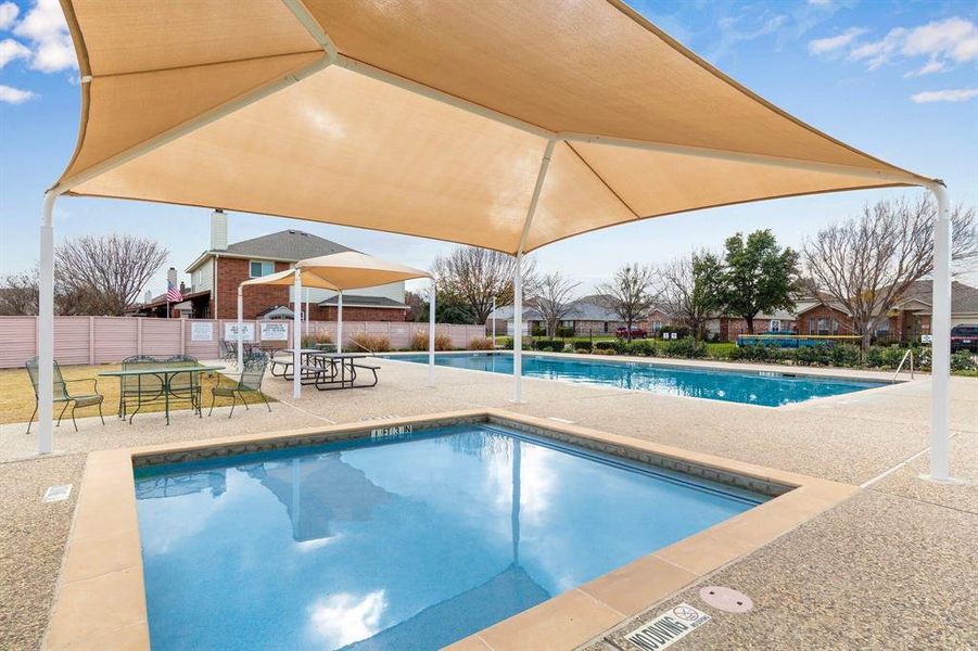 Community pool with a patio area Community pool with a patio area