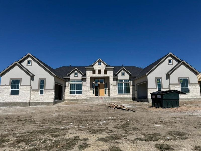View of front of home with stone siding and stucco siding