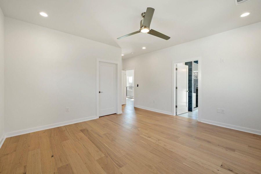 Empty room with baseboards, ceiling fan, light wood finished floors, and recessed lighting