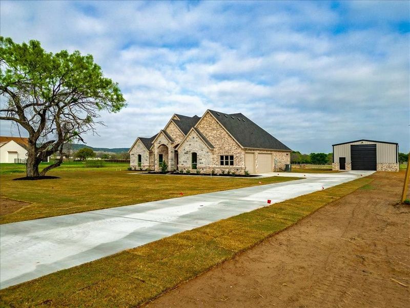 Front exterior of a new home in , Granbury, TX, highlighting curb appeal (Image 2). Front exterior of a new home in , Granbury, TX, highlighting curb appeal (Image 2).
