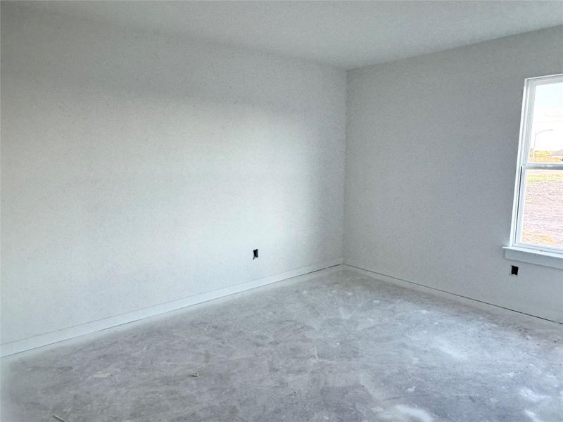 Unfurnished room featuring concrete flooring