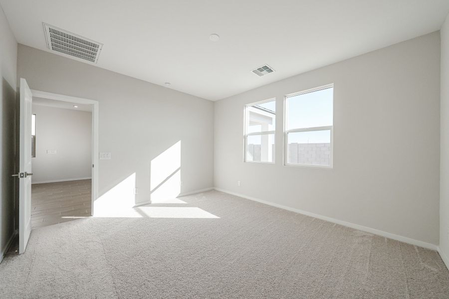 A room with a carpet and a door. A room with a carpet and a door.