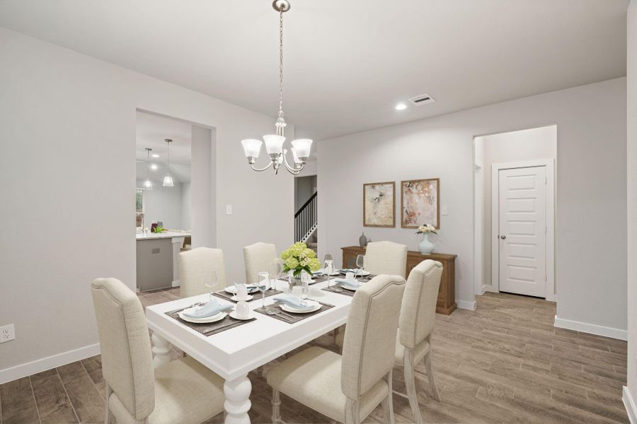 Make memories gathered around the table with your family and friends! This dining spacious room features elegant flooring, custom paint, and adjacent to kitchen for open concept feel. Sample photo of completed home with similar floor plan. As-built interior colors and selections may vary.