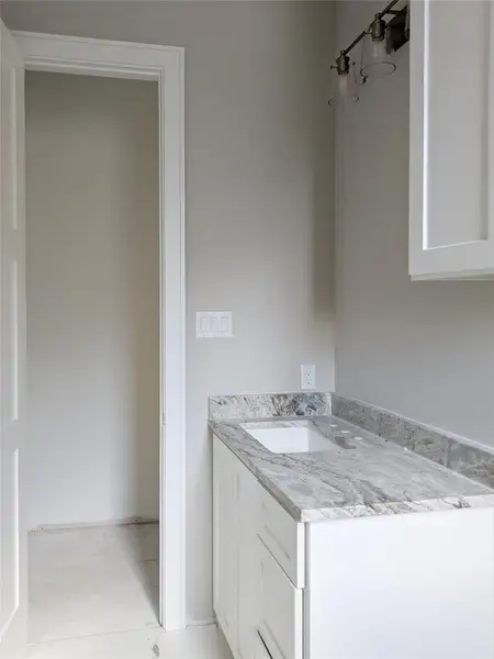 Guest bath vanity and closet entry. Guest bath vanity and closet entry.