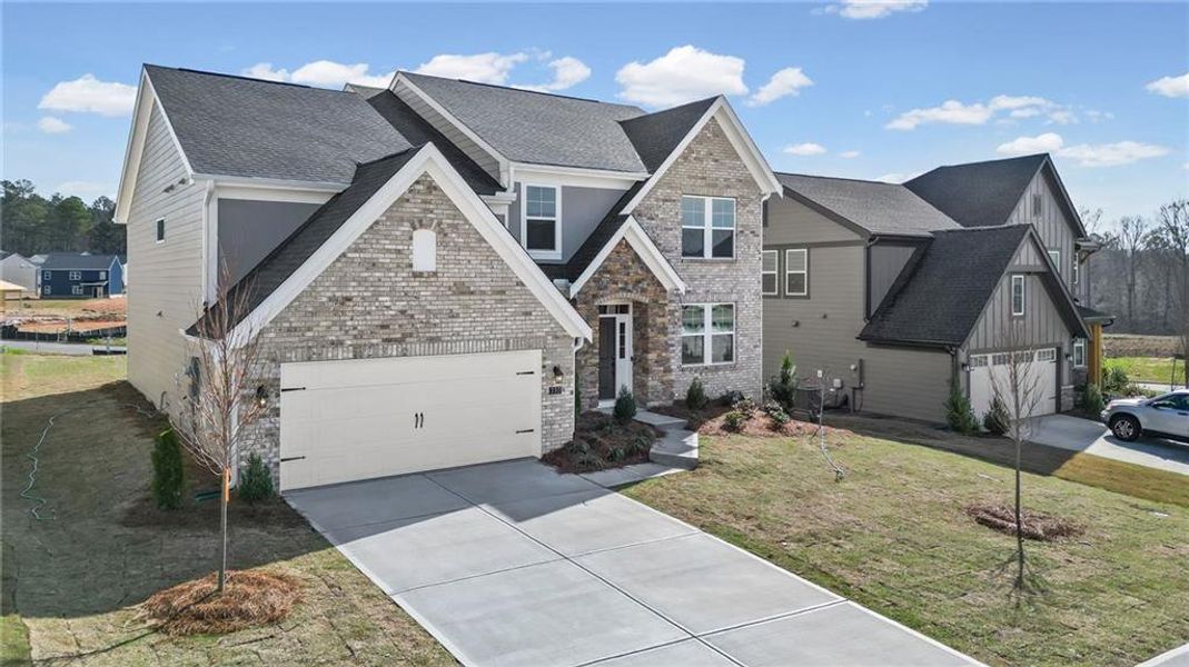 Front exterior of a new home in Twin Lakes, Hoschton, GA, highlighting curb appeal (Image 23). Front exterior of a new home in Twin Lakes, Hoschton, GA, highlighting curb appeal (Image 23).