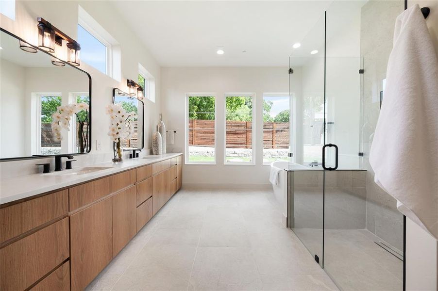 Bathroom with double vanity, an enclosed shower, and tile patterned floors