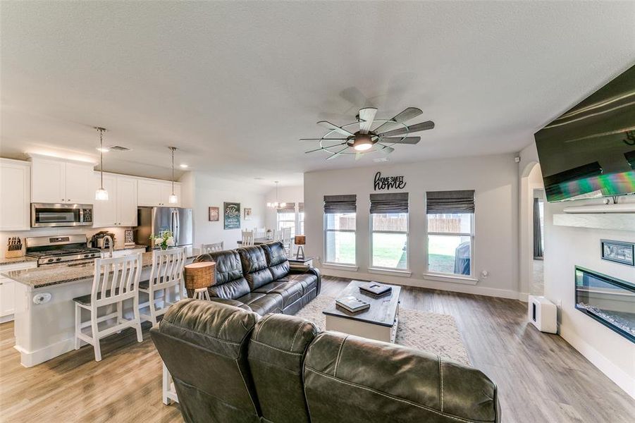 Living room featuring ceiling fan and light hardwood / wood-style floors