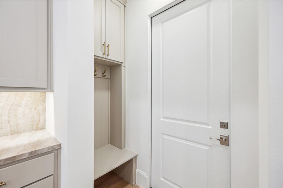 This drop zone can be found between garage and kitchen. With hooks, a bench, and storage cabinet, this space functions perfectly as a transition space. This drop zone can be found between garage and kitchen. With hooks, a bench, and storage cabinet, this space functions perfectly as a transition space.