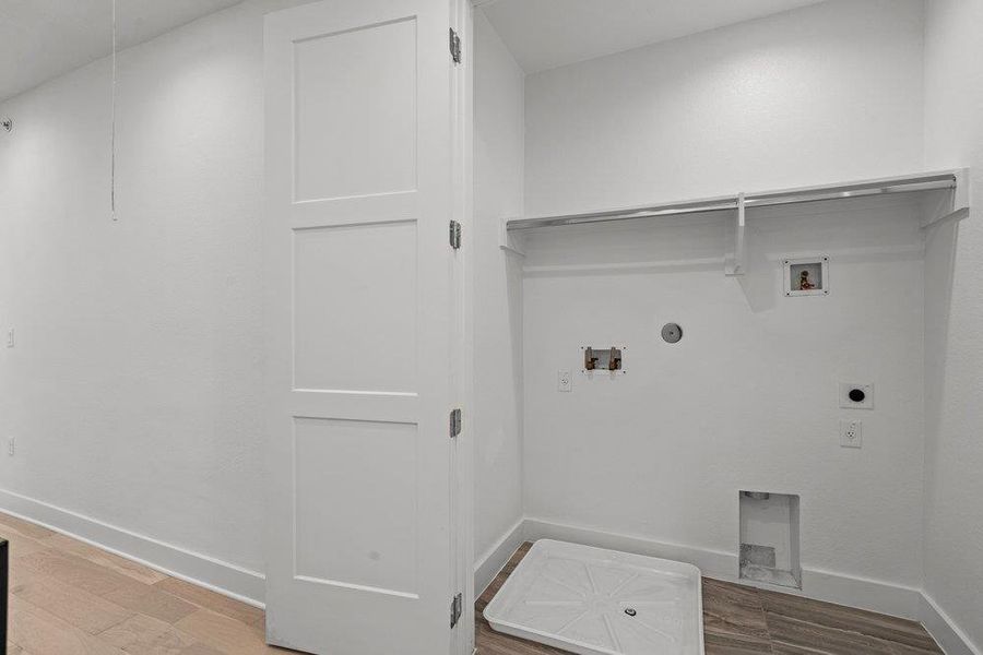 Functional utility space includes built-in wire shelving and dedicated plumbing connections. Functional utility space includes built-in wire shelving and dedicated plumbing connections.