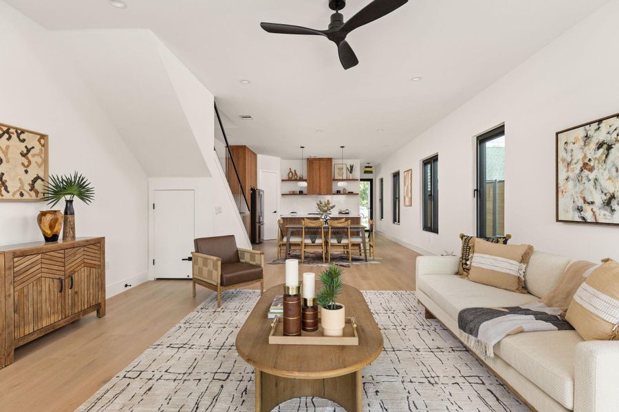 An open-concept living space integrates a well-appointed kitchen and dining area, boasting hardwood flooring and ample natural light.