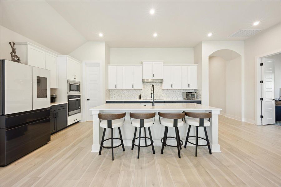 Kitchen featuring spacious island, stainless steel appliances and walk in pantry