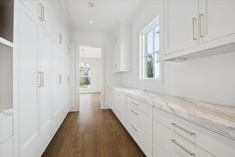 Pantry off the kitchen that has tons of storage, coffee bar area, and tucked away microwave area. Pantry off the kitchen that has tons of storage, coffee bar area, and tucked away microwave area.