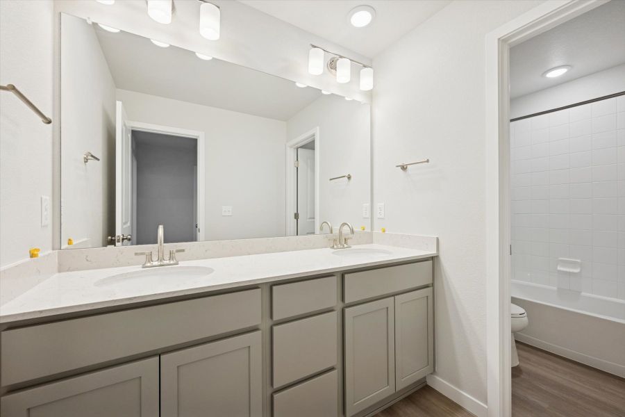 A bathroom with a large mirror.