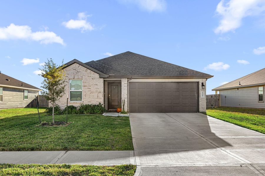 Front exterior of a new home in , Sealy, TX, highlighting curb appeal (Image 1).