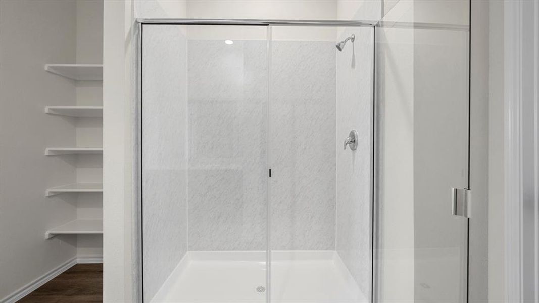 Full bath featuring a stall shower and dark wood-style flooring
