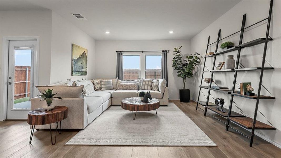 Living area with wood finished floors and recessed lighting
