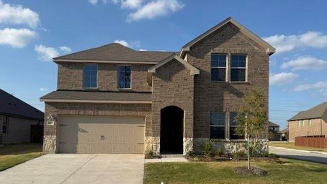 Front exterior of a new home in Fireside by the Lake, Garland, TX, highlighting curb appeal (Image 1). Front exterior of a new home in Fireside by the Lake, Garland, TX, highlighting curb appeal (Image 1).