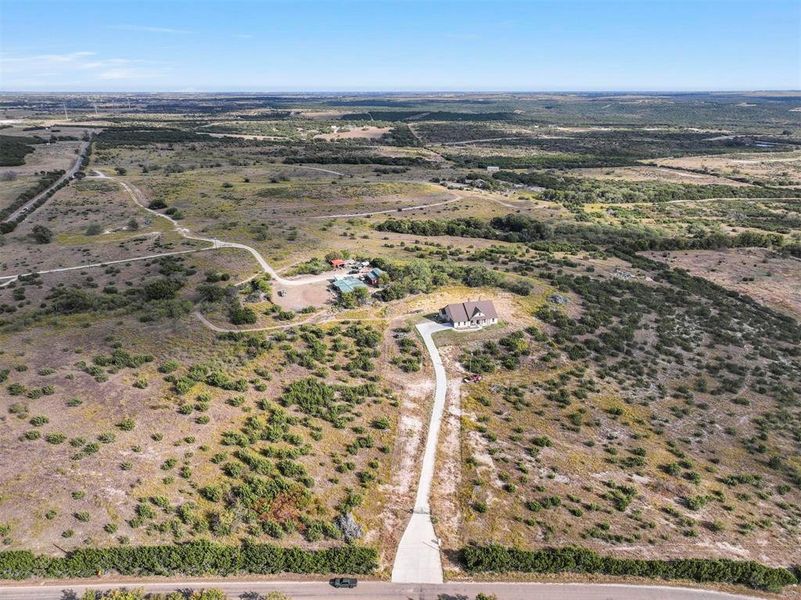 Birds eye view of property with a rural view