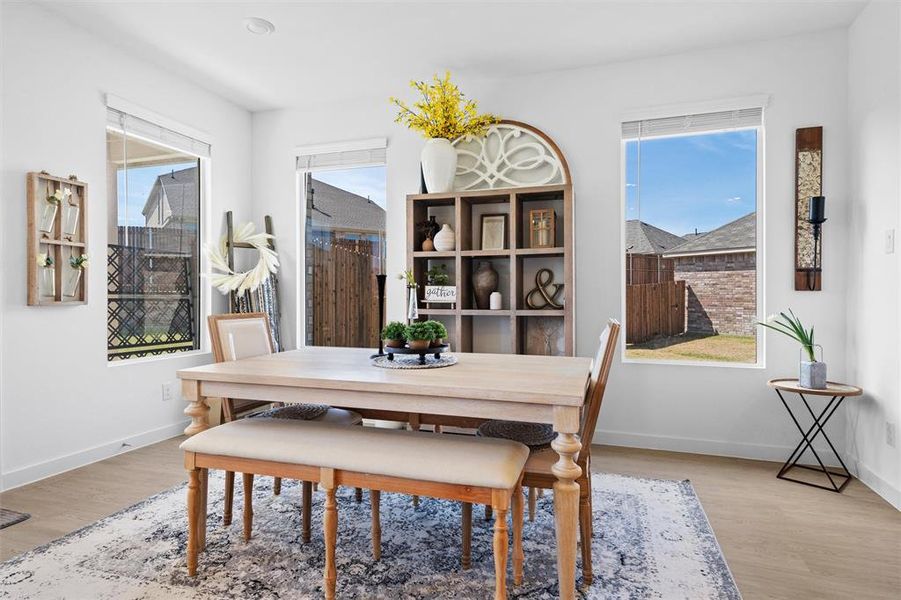 Dining room featuring light LVP finished floors and plenty of natural light Dining room featuring light LVP finished floors and plenty of natural light