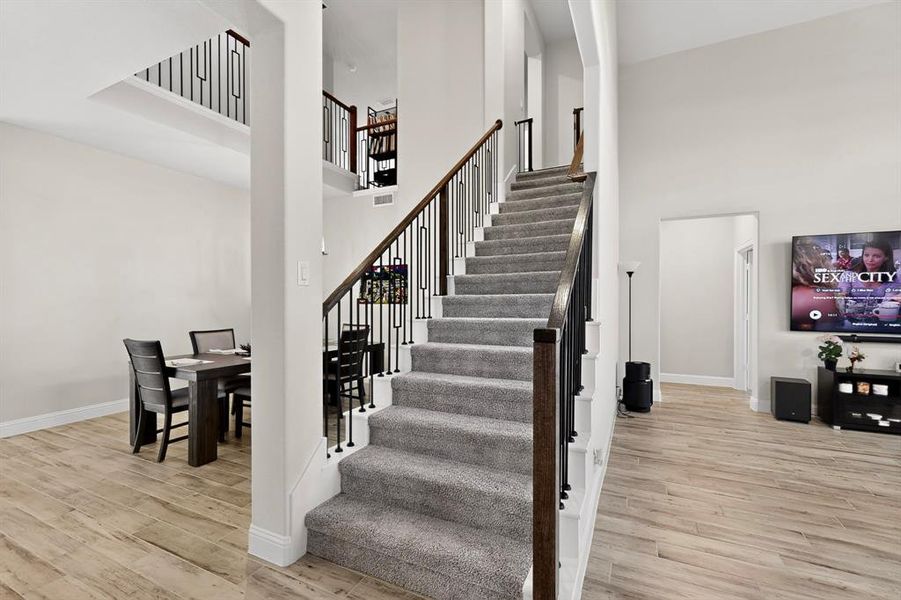 Stairs with wood finished floors and a towering ceiling Stairs with wood finished floors and a towering ceiling