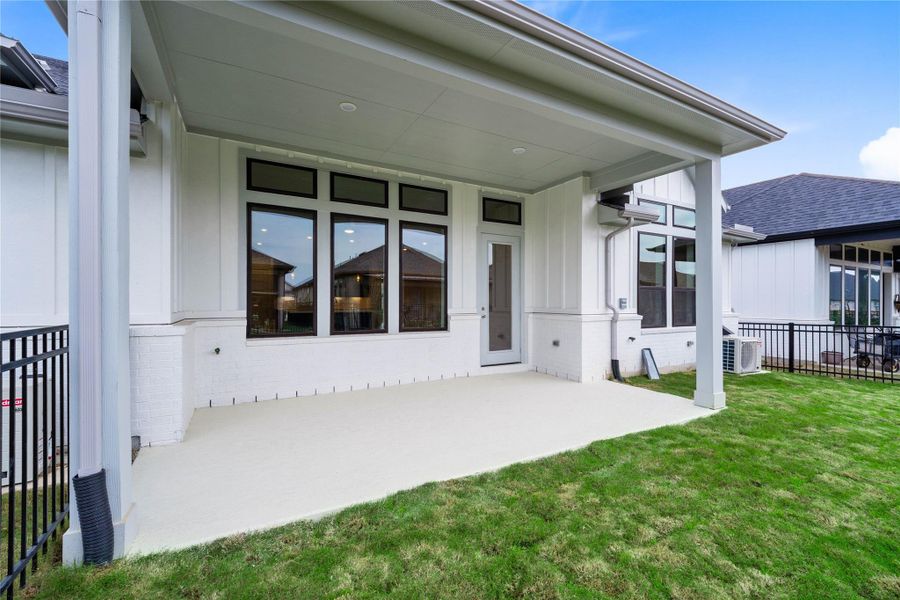 Step outside to the covered rear patio, the perfect extension of your indoor living space for year-round enjoyment.