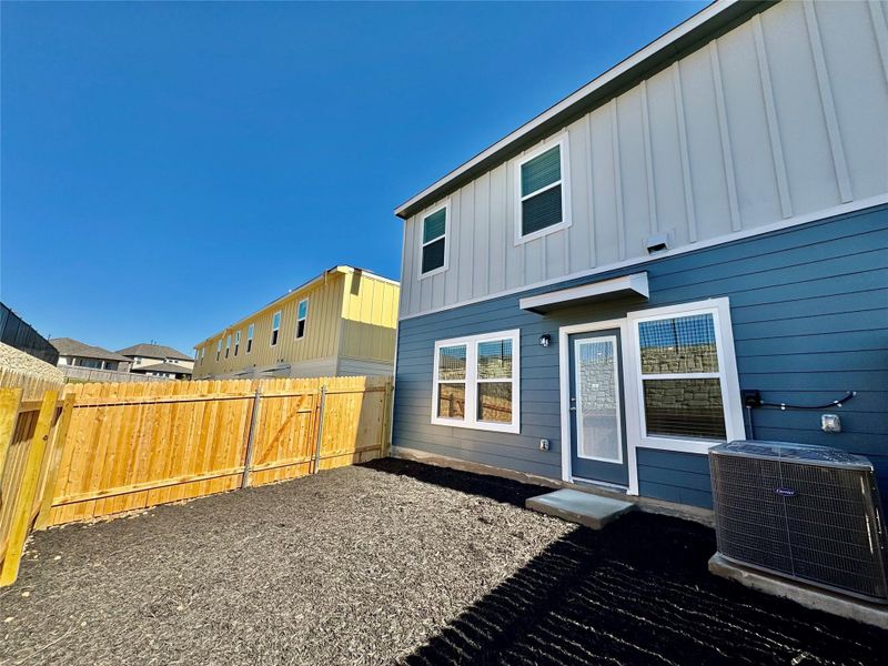 Rear view of house with board and batten siding and a residential view Rear view of house with board and batten siding and a residential view