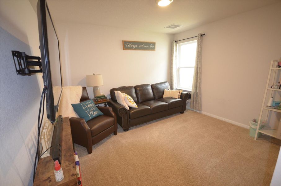 Carpeted living room featuring baseboards Carpeted living room featuring baseboards