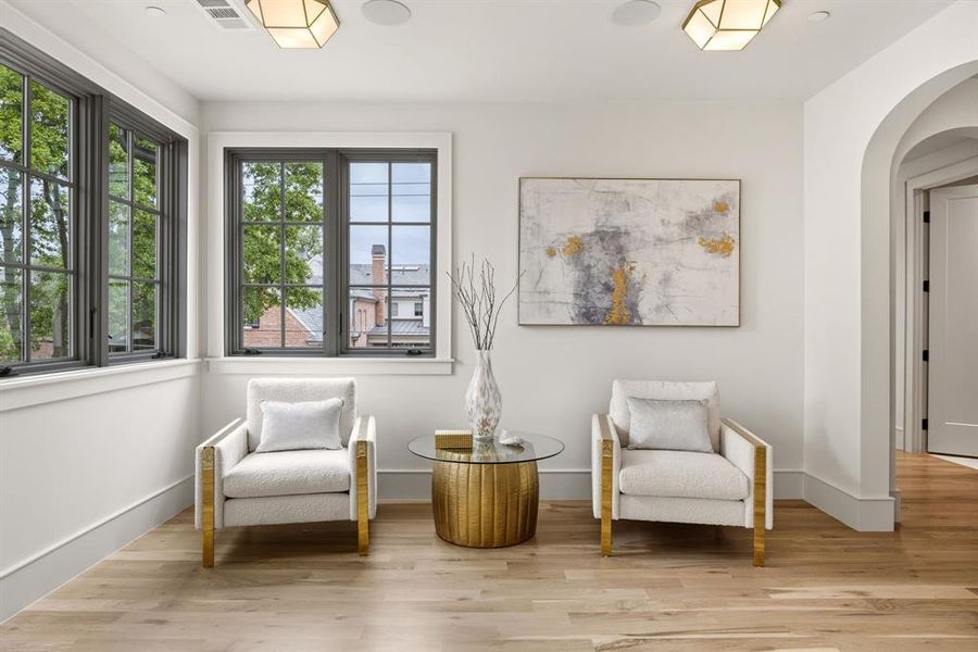 White oak wood-finish flooring complements the modern white walls and arched doorway White oak wood-finish flooring complements the modern white walls and arched doorway