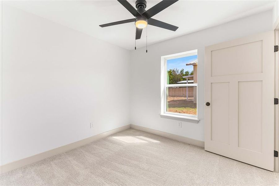 Unfurnished bedroom featuring carpet flooring and a ceiling fan Unfurnished bedroom featuring carpet flooring and a ceiling fan