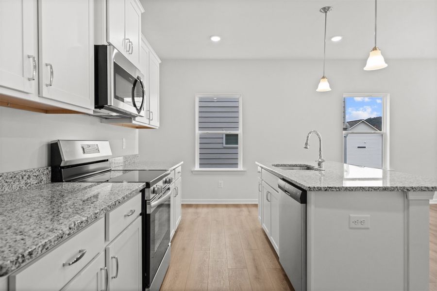 The Dove- Kitchen. Home under construction, photo used for illustrative purposes only, colors and options will vary.