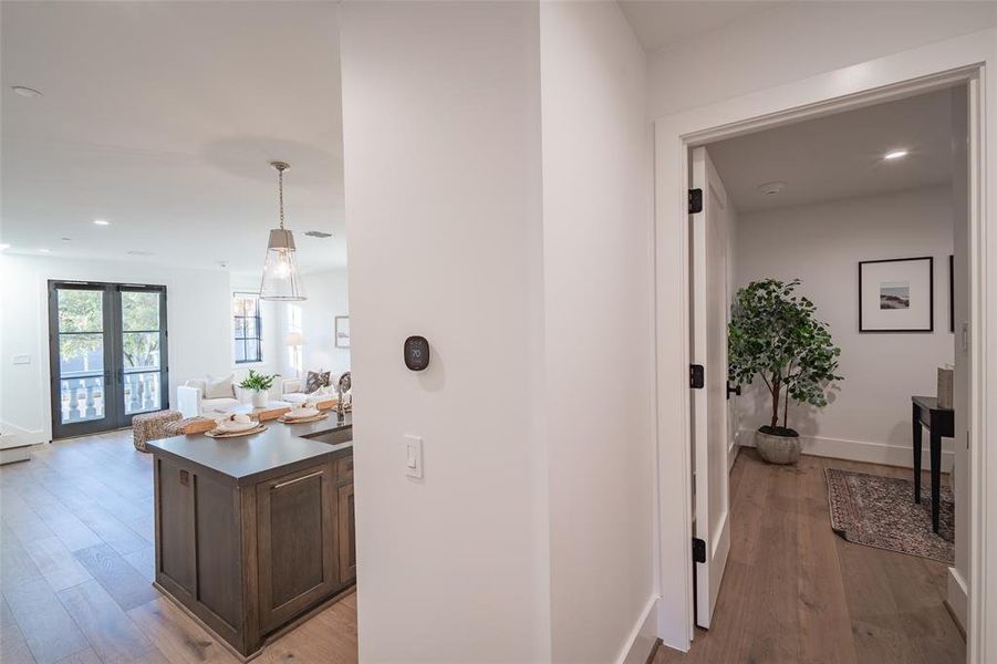 Hallway with sink and light hardwood / wood-style flooring