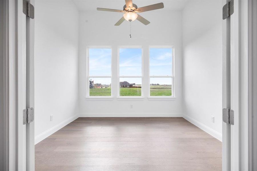 Office or flex space with light hardwood / wood-style flooring and ceiling fan