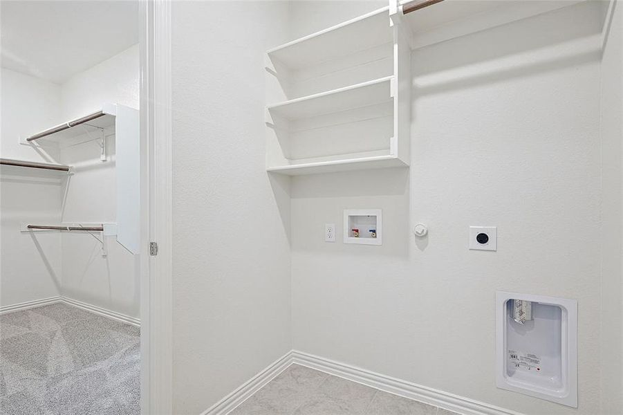 Laundry area featuring electric dryer hookup, gas dryer hookup, and washer hookup