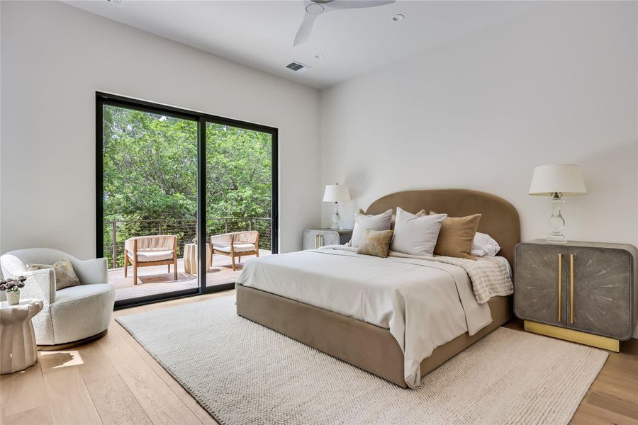 Bedroom with light wood-finish flooring and a large area rug