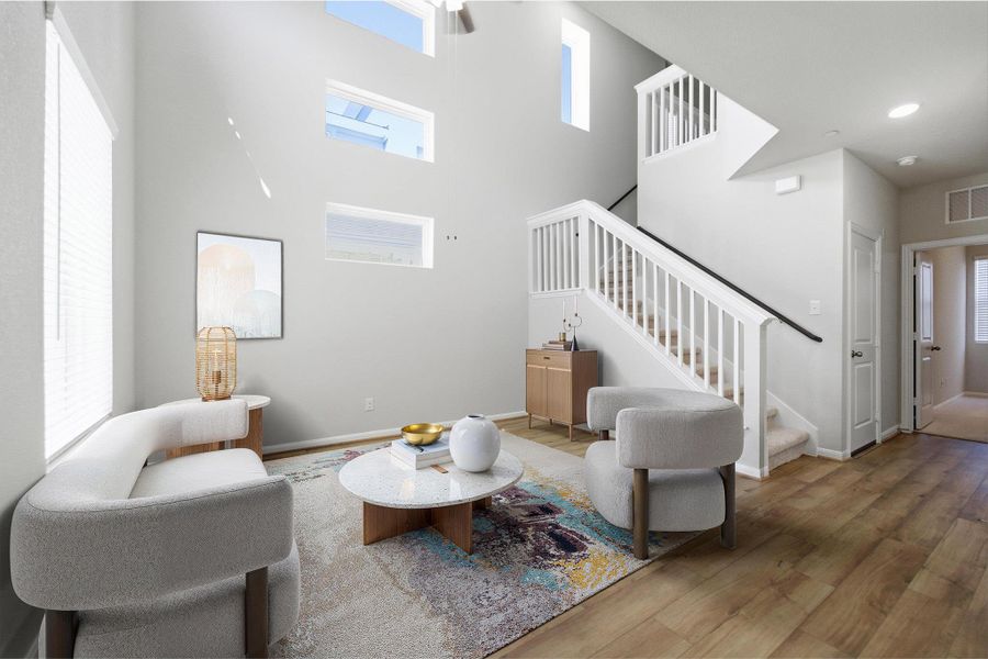 Living room with wood finished floors and a high ceiling