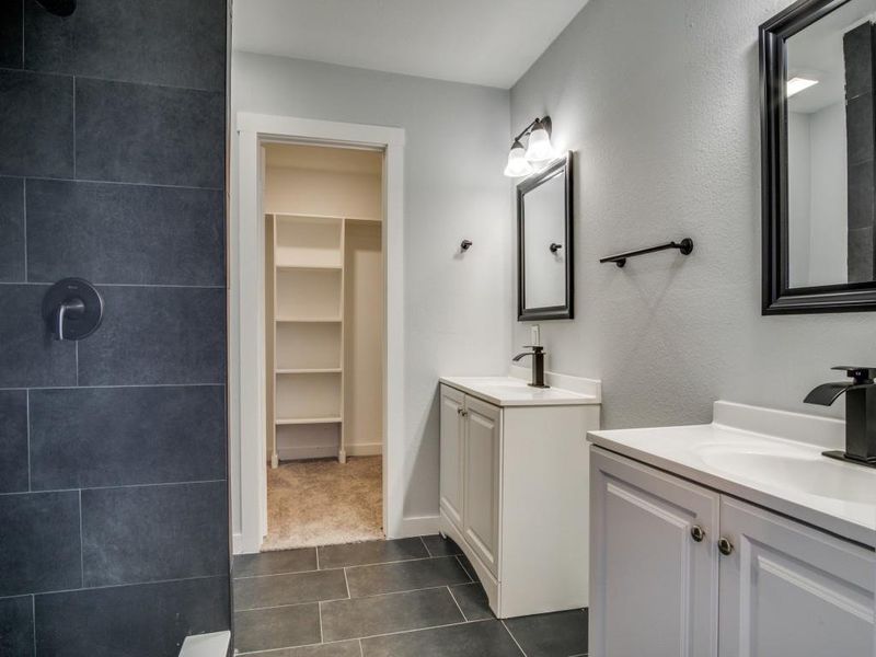 Bathroom featuring dual bowl vanity and tile patterned flooring Bathroom featuring dual bowl vanity and tile patterned flooring