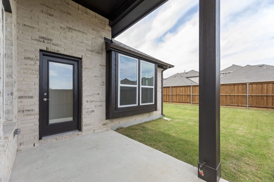 Exterior details and patio area of a home in The Reserve at Spiritas Ranch, Little Elm (Image 3).