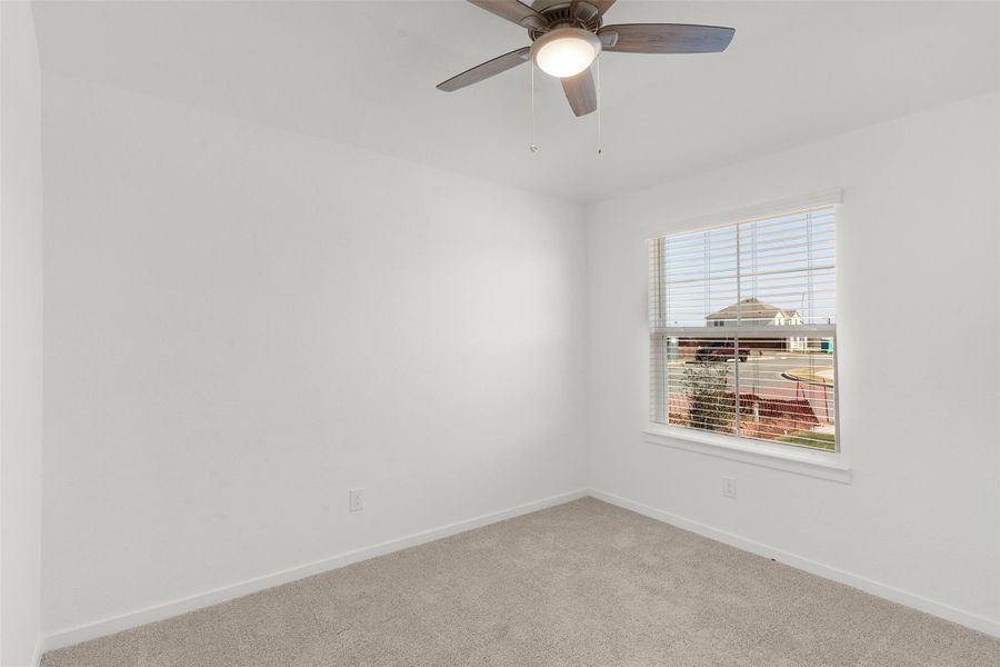 Spare room with ceiling fan and carpet floors
