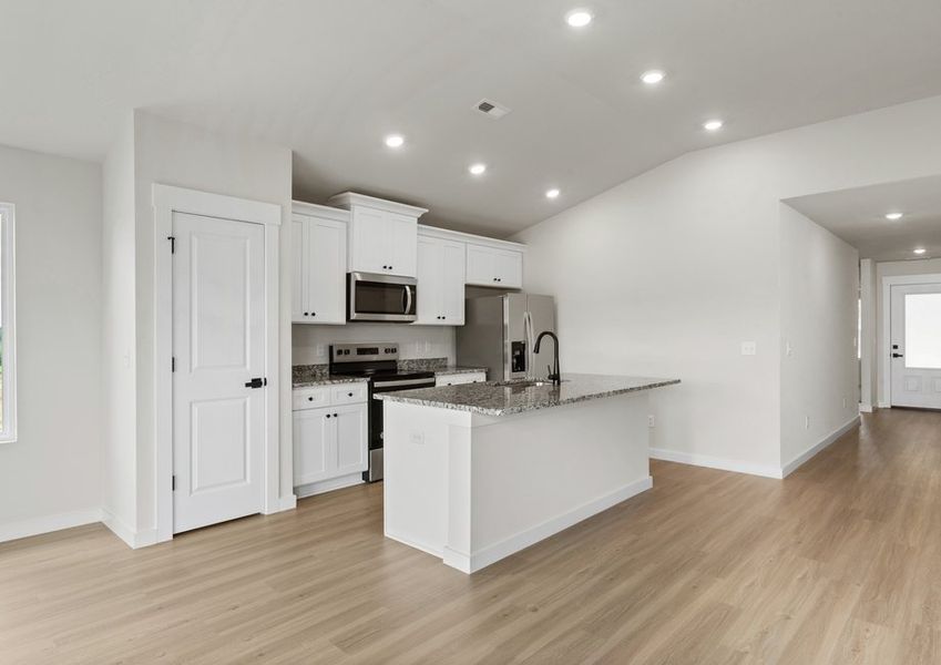 The living room connects to the kitchen