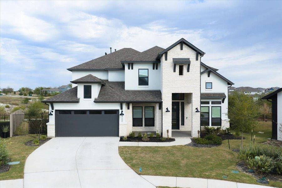 View of front of house featuring a shingled roof, driveway, a garage, stone siding, and stucco siding View of front of house featuring a shingled roof, driveway, a garage, stone siding, and stucco siding