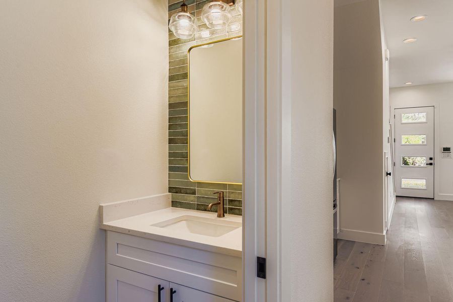 Bathroom featuring vanity, wood-type flooring, and recessed lighting Bathroom featuring vanity, wood-type flooring, and recessed lighting