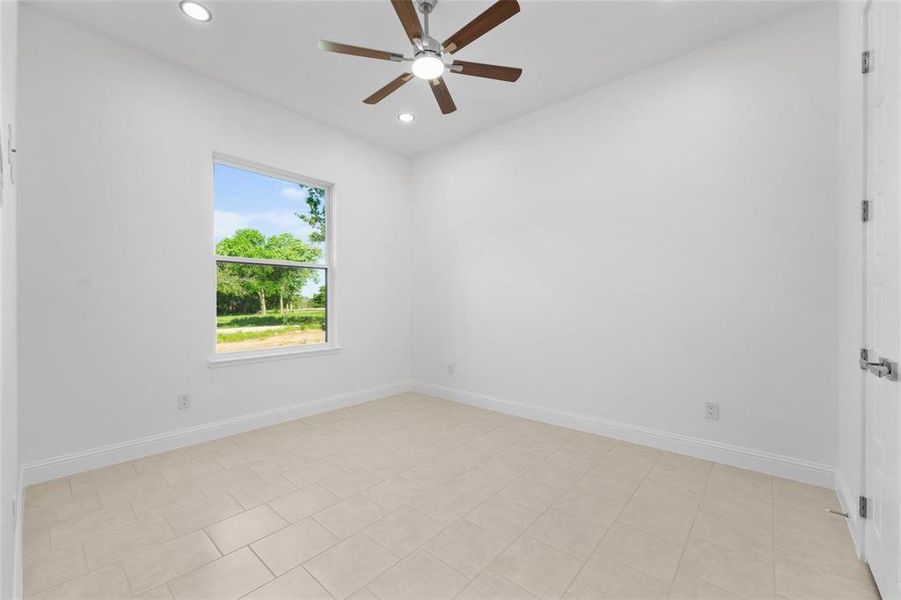 Spare room with recessed lighting, ceiling fan, and light tile patterned floors Spare room with recessed lighting, ceiling fan, and light tile patterned floors