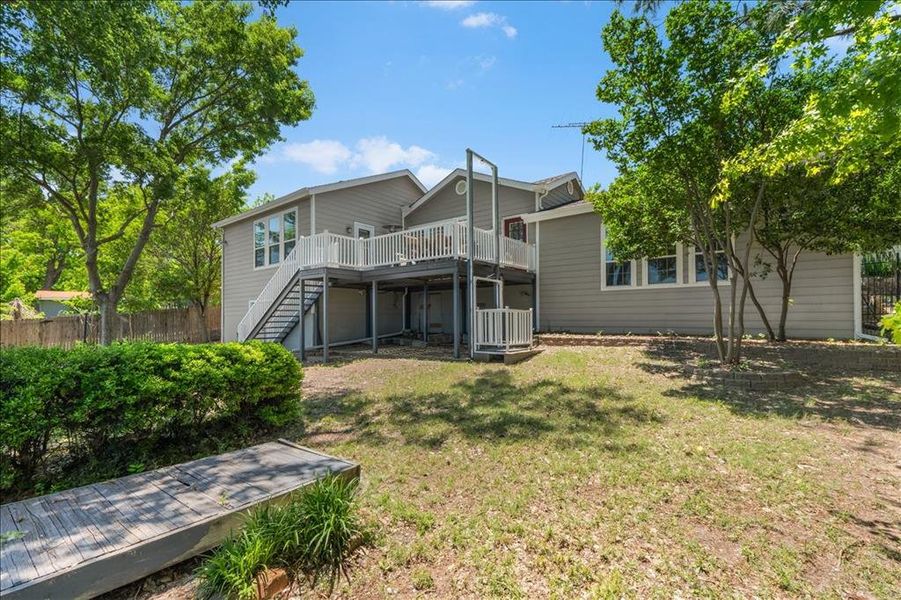Back of property with stairway and a wooden deck