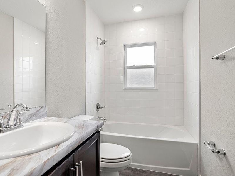 Guests and secondary bedrooms share a convenience hall bath.