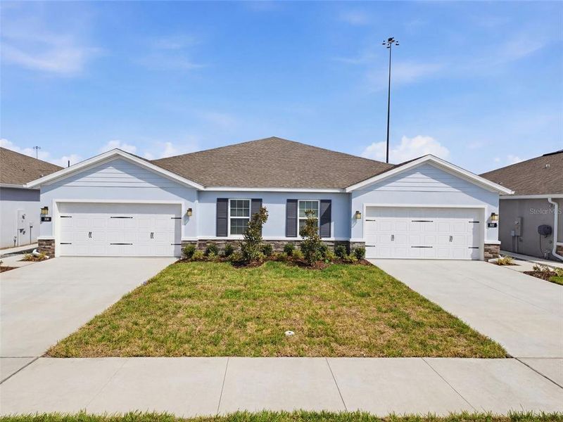 Front exterior of a new home in Park Ridge Villas, Spring Hill, FL, highlighting curb appeal (Image 22).